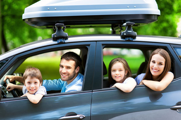 family in car depicting safe driving in summer