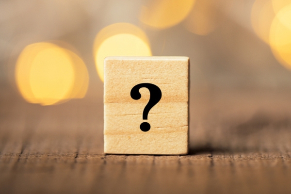 question mark on wooden chip depicting FAQS about windshield chip repair problems