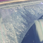 image of a windshield covered with sand and pits