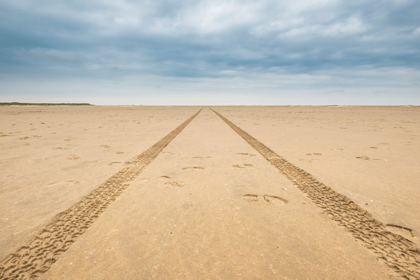 image of car driving in a sandy area