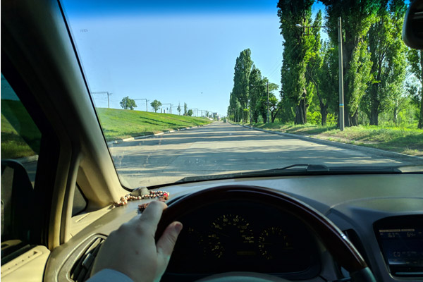 image of a person looking through windshield while driving a motor home