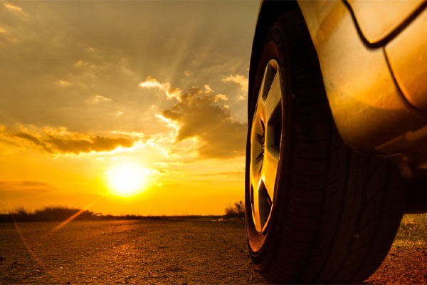 car driving in the sun depicting protection of tinted car glass