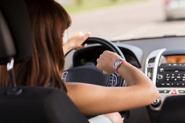 car owner looking at watch depicting saving time with mobile car glass repairs