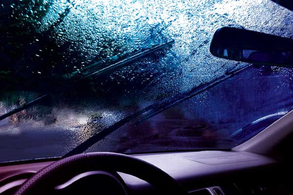 image of a car in rain depicting a windshield leak