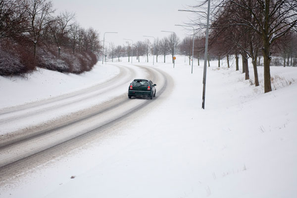 image of a car driving in winter weather