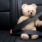 image of a teddy bear with seatbelt depicting used auto glass and safety