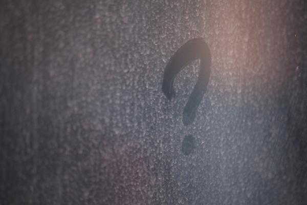 question mark on dirty glass surface depicting FAQs about windshields