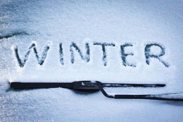 image of the word winter on windshield depicting winter windshield damage