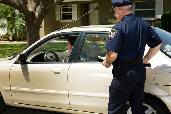 image of driver getting pulled over depicting legal issues with chipped or cracked windshield