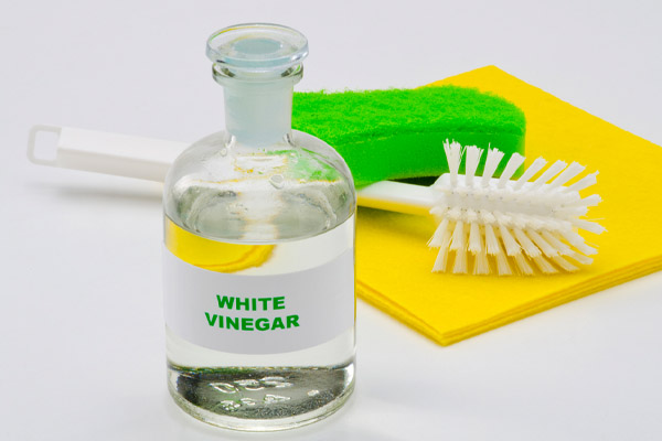 image of white vinegar depicting how to clean car windows