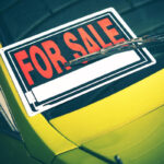 image of a car with for sale sign depicting auto glass and car resale value