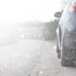 driving in snow depicting cracked windshield repair in winter