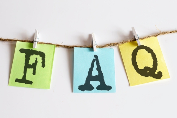 FAQ on colored papers clipped on a thin rope depicting questions about Auto Glass Repair Types