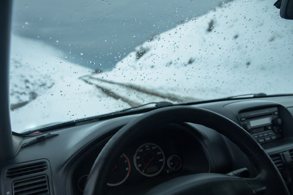 car with snow in window windshield in winter