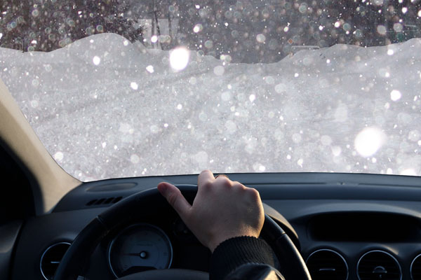 image of windshield and driving in snow fall and poor conditions