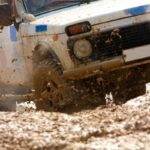 off-road vehicle rolling in mud