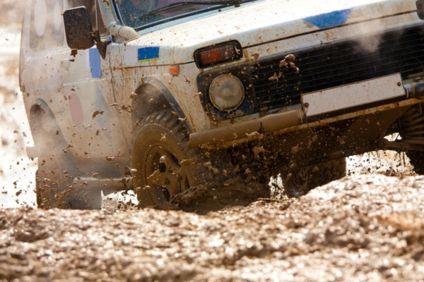 off-road vehicle rolling in mud