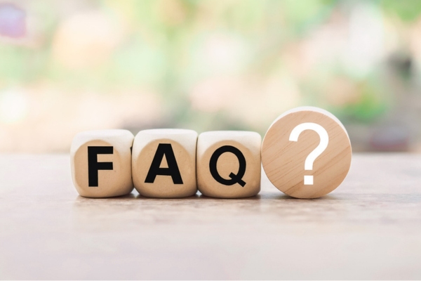 FAQ spelled using wooden letter dice depicting questions about hail damage and auto glass