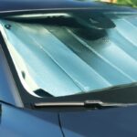 Foldable sun shade under windshield inside