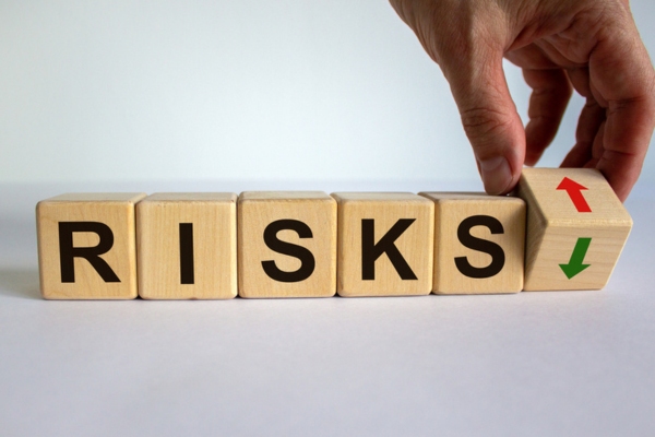 risks spelled using wooden letter cubes depicting ignoring windshield leak