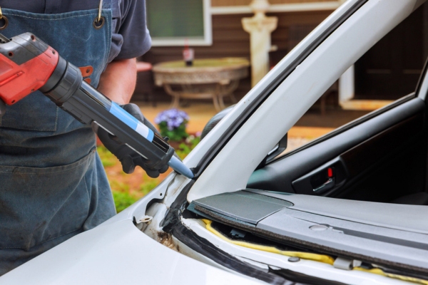 technician working on windshield seal