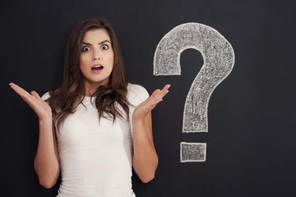 woman looking shocked while shrugging beside a big question mark doodle depicting What to Do If Your Windshield Is Leaking