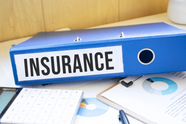 document binder labeled as insurance depicting considerations for OEM vs. Aftermarket Auto Glass